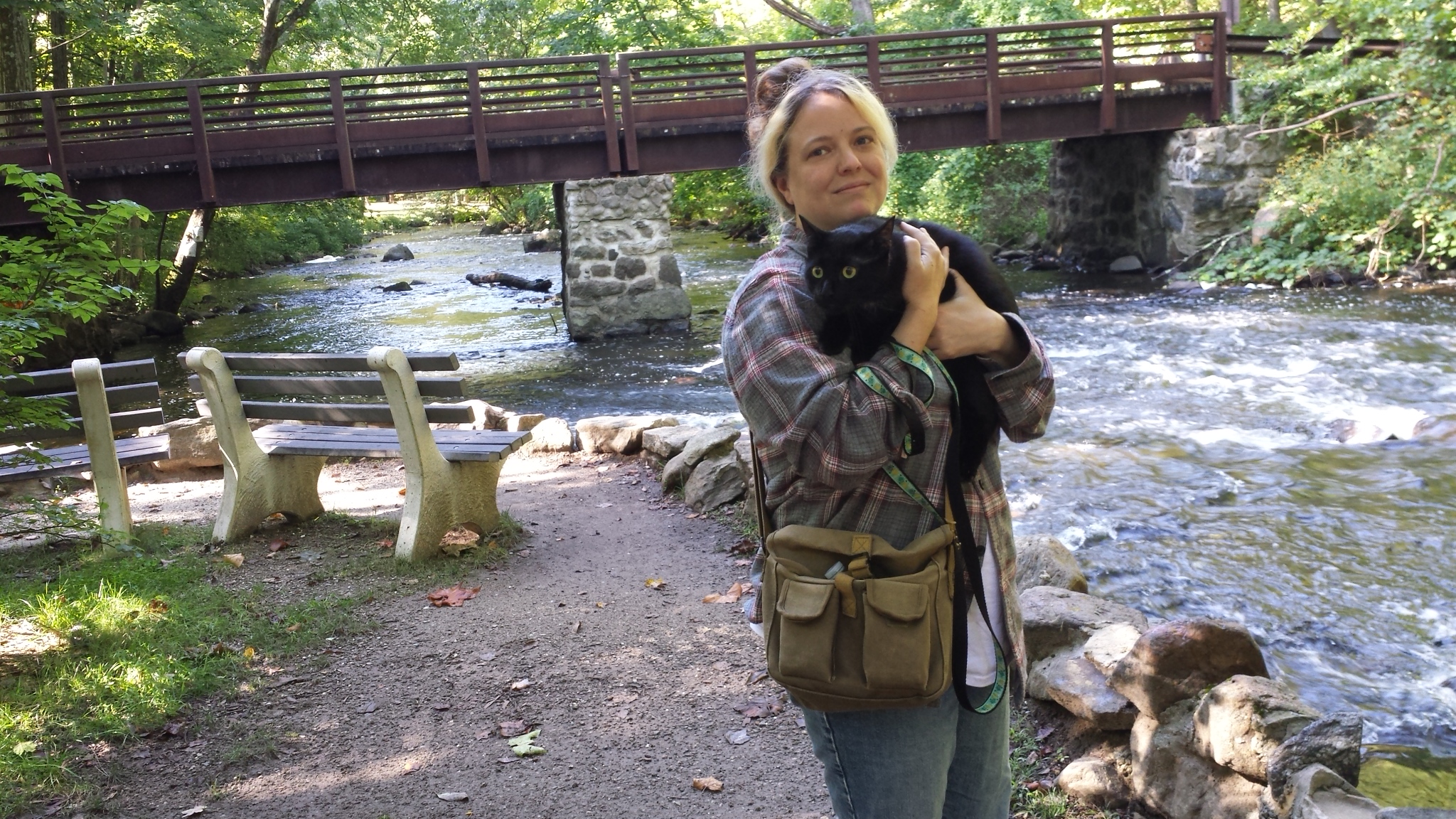 Amber holding Gus next to river