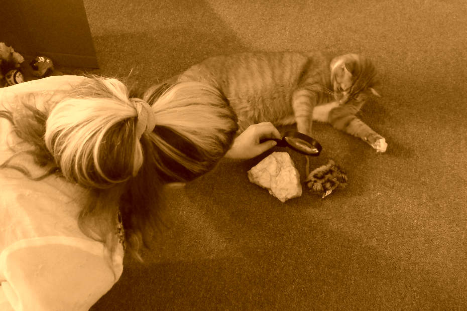 sepia tone; Amber and Ollie studying evidence with a magnifying glass