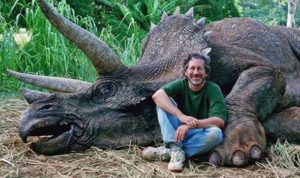 Movie set photo of Spielberg with prop of a dead Triceratops by Jay Branscomb