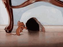 Tom & Jerry cartoon; mouse dancing back to hole in wall