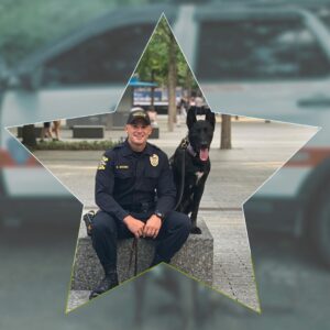 in a star shape, Ptl Overko and K9 Camo sitting on a bench; background is the K9 cruiser with Camo blurred