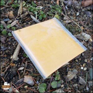 close up of the individually wrapped slice of American cheese on the ground
